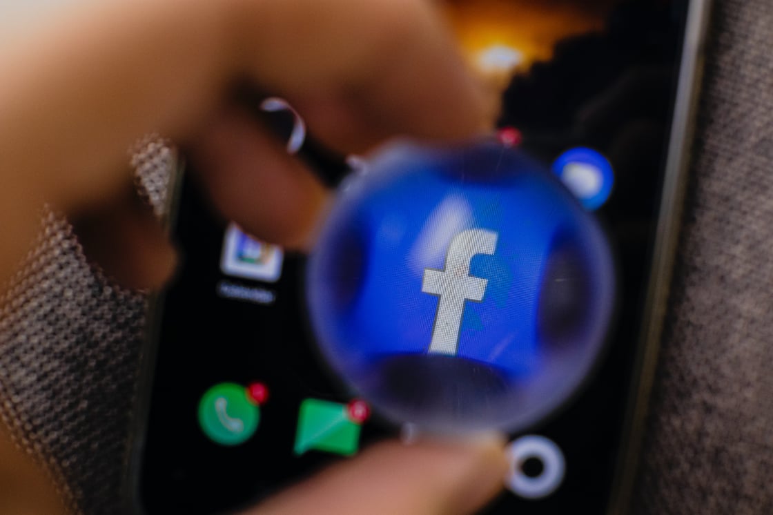 imagen del logo de Facebook mirado a través de un cristal con aumento